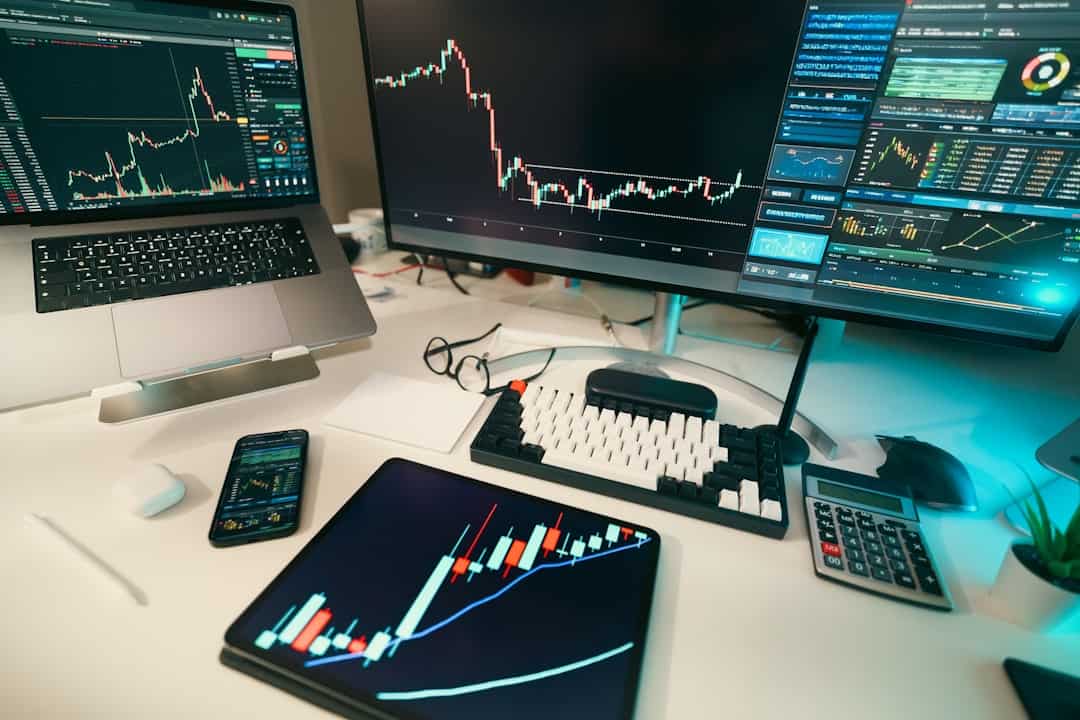 a professional workspace showing multiple screens displaying various income dashboards, charts, and financial apps